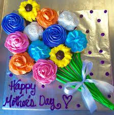 a birthday cake decorated with flowers and the words happy mother's day