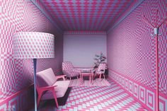 a pink and blue room with chairs, table and lamp