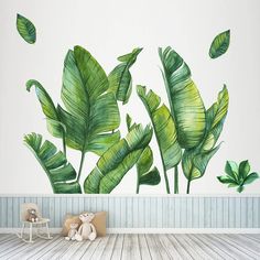 there is a wall mural with green leaves on it