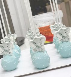 there are three elephant figurines on top of each other in front of a mirror