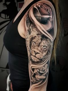 a woman with a lion and rose tattoo on her arm