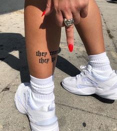 a woman's leg with the words they run, they fly on it and her finger tattoo