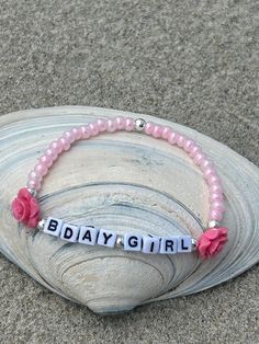 "This \"BDAY GIRL\" customizable stretch bracelet is the most adorable thing and a true must have.  It looks like a birthday cake and is the perfect gift for someone celebrating their birthday.  The beads are 4 mm pale pink matte seed beads and are complimented with an 8mm darker pink rose on each side of the text and outlined by sterling silver plated 4mm beads.  The lettering consists of 5mm cube beads that read \"BDAY GIRL\".  Absolutely gorgeous and makes the wearer feel like a true birthday Handmade Pink Beaded Bracelets For Birthday, Pink Beaded Name Bracelet For Birthday, Pink Beaded Bracelet With Custom Name For Birthday, Pink Beaded Stretch Bracelet For Birthday, Pink Name Bracelet For Birthday, Bday Girl, Pink Birthday, Princess Birthday, Pale Pink