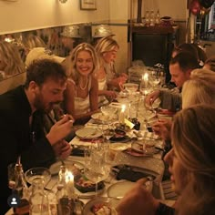 a group of people sitting around a dinner table