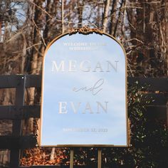 a welcome sign for the newlywed couple to wed in front of a wooded area