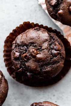 two chocolate muffins sitting next to each other