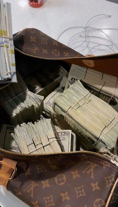 a purse filled with money sitting on top of a table