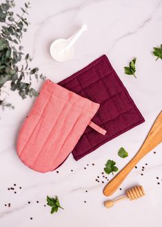 two cloths and wooden utensils on a table