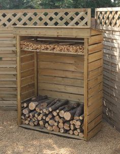 an outdoor firewood storage unit with logs in it