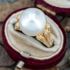 This stunning pearl ring is centered with one (1), post set, cultured South Sea pearl. The shoulders of the ring are each accented with sixty-one (61), bead set, round brilliant cut diamonds. The ring measures 13.6mm at the top, rises 16.0mm above the finger, tapering to 2.8mm wide and 1.1mm thick at the base of the shank. It is currently fits s size 8.5. Pearl And Diamond Ring, South Seas, Sea Pearls, South Sea Pearls, Pearl Diamond, Pearl Ring, Round Brilliant Cut Diamond, Brilliant Cut Diamond, Jewelry Rings