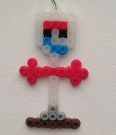 two legos made to look like they are hanging on the wall, one is red and one is blue