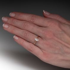 a woman's hand with a diamond ring on it