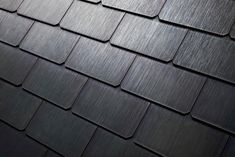 a close up view of a black shingled roof