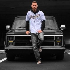 a man sitting on the hood of a truck