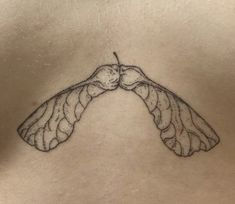 the back of a woman's stomach with a bird tattoo on her left side