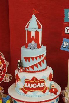 a circus themed birthday cake with an elephant on the top and circus tent in the background