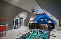 a game room with foosball tables and chairs