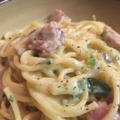 a close up of a plate of pasta with meat