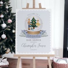 a baby shower sign next to a christmas tree