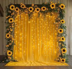 sunflowers and greenery decorate the backdrop for an event