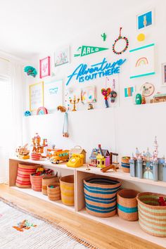 there are many baskets and toys on the shelves in this kids's playroom