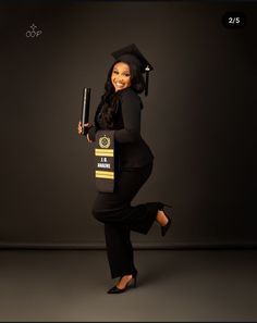 a woman dressed in a black outfit and holding a bat is posing for the camera