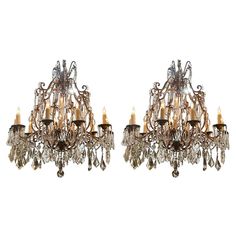 a pair of chandeliers with crystal drops on the bottom and gold trimmings