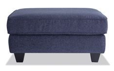 a blue foot stool with wooden legs and an upholstered cushion on the bottom