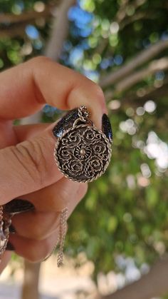 Small circular medallions decorated with intrincate filigree. The pattern reminds me of a labyrinth with a tiny filigree flower at the centre.  The diameter of the pendant measures aprox. 1,5 cm. This listing is only for the pendant. Chain not included. Ornate Medallion Coin Pendant Jewelry, Ornate Medallion Jewelry With Coin Pendant, Ornate Antique Silver Medallion Necklace, Ornate Antique Silver Medallion Jewelry, Ornate Coin Pendant Jewelry, Ornate Engraved Medallion Necklace, Ornate Medallion Necklace Nickel-free, Ornate Medallion Necklace Nickel Free, Ornate Medallion Nickel-free Necklace