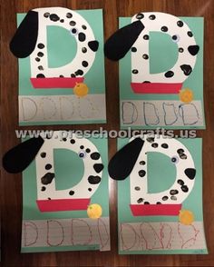 the letter d is made out of paper and has black dots on it's edges