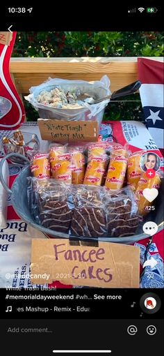 a table topped with lots of food and drinks on top of a wooden table covered in signs