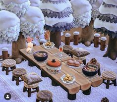 a picnic table is set up in the middle of a snowy forest with lots of food on it