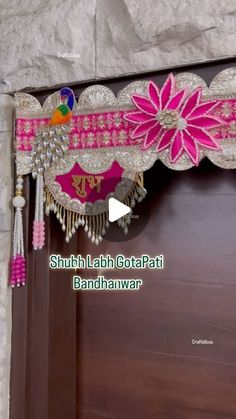 the door is decorated with pink flowers and tassels