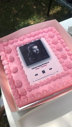 a pink cake with an image of abraham lincoln on the front and side, sitting on top of a table