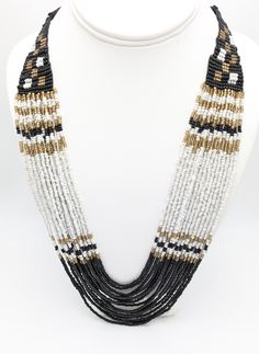 Black and white waterfall necklace. Multi strand, torsade necklace.  Glass seed beads. 16 strands. Adjustable length. 24 to 27 inches.  This has never been worn. NOS New old stock.  To continue shopping in my store, click the link below: https://www.etsy.com/shop/MagicOfLee Bohemian White Multi-strand Layered Necklace, Multi-strand Beaded Necklaces, Adjustable White Beaded Layered Necklace, Adjustable Multi-strand Beaded Necklaces, White Multi-strand Beaded Necklaces, White Multi-strand Beaded Necklace, Multi-strand Beaded Necklace With Large Beads, White Multi-strand Bohemian Beaded Necklaces, White Multi-strand Beaded Necklace With Large Beads