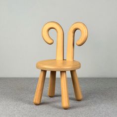 a wooden chair sitting on top of a gray floor