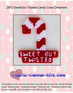 the candy cane is made out of red and white crocheted yarn, which says sweet but twisted candy cane ornament