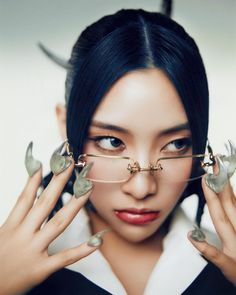 a woman wearing glasses with horns on her head and nails in front of her face