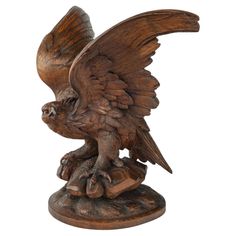 a wooden statue of an eagle on a white background