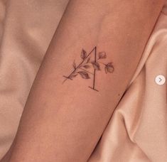 a woman's arm with a small tattoo on the left side of her leg