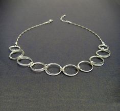 "Elegant Silver Circles Necklace Silver Rings Necklace ~ Elegant and organic, coiled rings of sterling silver wire linked together to create a flowing circle chain. Embellished with wire wrapped silver beads and finished with a lobster clasp and extender chain ending in a silver drop.  Adjustable length, whichever length you choose will include an additional 1 1/2\" extender chain. Your purchase will arrive beautifully packaged in a floral jewelry box tied with a ribbon bow ready for giving, or Modern Twist Silver Wire Wrapped Jewelry, Silver Infinity Ring, Open Circle Necklace, Circle Chain, Circle Jewelry, Rings Necklace, Floral Jewelry, Wire Necklace, Circle Necklace