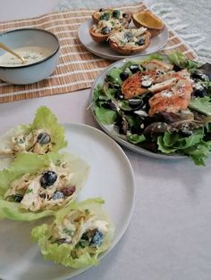 two plates with food on them sitting on a table