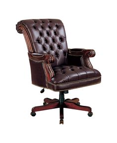 a brown leather office chair sitting on top of a wooden desk