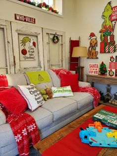 a living room filled with furniture and christmas decorations on top of it's walls