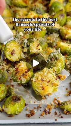 someone is sprinkling the brussel sprouts with a spatula