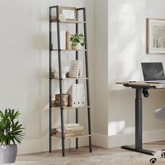 a laptop computer sitting on top of a wooden desk next to a book shelf filled with books