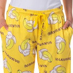 Step into a world of vibrant comfort with these bright yellow Bananya pants. Bananya is an optimistic and carefree cat that lives in a banana peel along with his friends Bananyako and Droopy-Eared Bananya. Bananya is the older sibling of the 3 bananyas in The Bananya Bunch. His lifelong dream is to become a trendy chocolate-covered bananya. Crafted with relaxation in mind, these pajama pants boast an elastic drawstring waistband, ensuring a snug yet adjustable fit that accommodates your comfort Yellow Relaxed Fit Sleepwear For Lounging, Playful Yellow Cotton Pants, Playful Yellow Bottoms With Elastic Waistband, Bananya Cat, Older Sibling, Banana Peel, Lounge Pajamas, A Banana, Drawstring Waistband