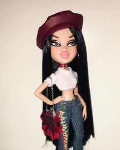 a doll with long black hair wearing jeans and a red hat on top of her head