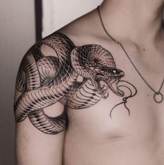 a man with a snake tattoo on his chest