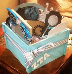 a blue box filled with assorted items on top of a table